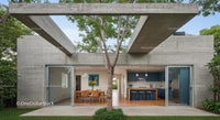 Modern Concrete Structure with Outdoor Dining and Tree Canopy