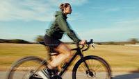 Female Cyclist Riding Through Scenic Countryside