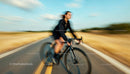 Blurred Cyclist Riding Fast on Open Road