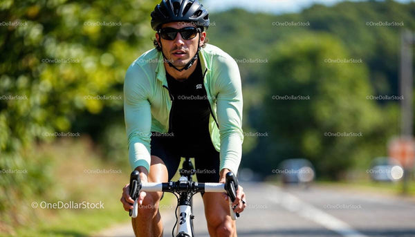 Focused Cyclist Riding on Sunny Day in Green Jacket