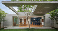 Modern Concrete Structure with Outdoor Dining and Tree Canopy
