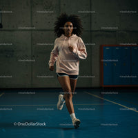 Woman Jogging Indoors in a Modern Gym Setting
