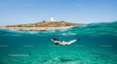 Snorkeler Explores Crystal Waters Near Lighthouse Island