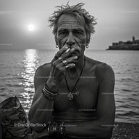 Rugged Man Smoking by the Ocean at Sunset