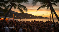 Vibrant Beach Party at Sunset with Palm Trees and Ocean