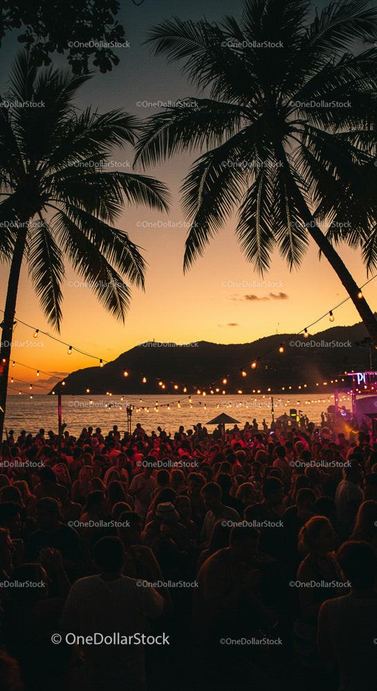 Vibrant Beach Party at Sunset with Palm Trees and Ocean View