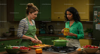 Two Women Cooking Together in a Colorful Kitchen