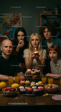 Friends Celebrating Birthday with Cupcakes and Candlelight