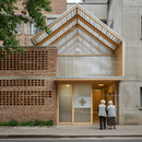 Elderly Couple at Modern Brick Building Entrance