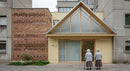 Elderly Women Standing Before Modern Urban Building