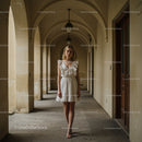 Elegant Woman in White Dress in Historic Archway