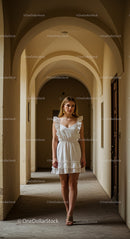 Elegant Woman in White Dress Under Classic Arches