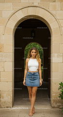 Stylish Woman in Denim Skirt Under Stone Archway