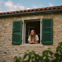Smiling Woman Leaning Out Stone House Window