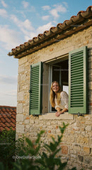 Woman Smiling from a Rustic Stone House Window