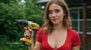 Confident Woman Holding Yellow Drill in Outdoor Setting