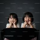Cheerful Girls Smiling Behind a Chair