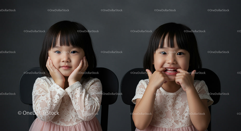Twin Girls in Lace Dresses with Playful Expressions