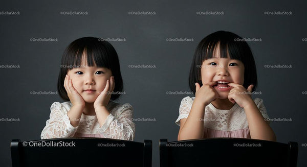 Adorable Twin Girls in Lace Dresses with Playful Expressions