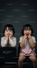 Playful Twin Sisters in Matching Lace Dresses