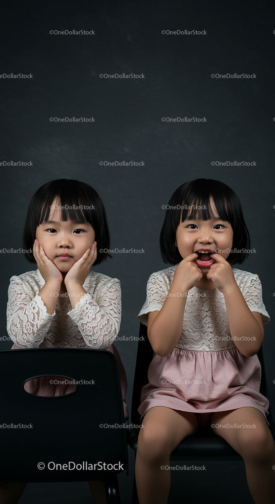 Playful Twin Sisters in Matching Lace Dresses