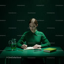 Woman in Green Writing at a Minimalist Desk