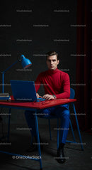 Focused Professional Man in Red Sweater and Blue Trousers
