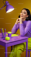 Smiling Woman at Bright Purple Desk with Modern Decor