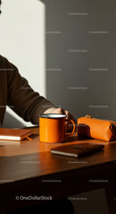 Cozy Workspace with Orange Mug in Warm Sunlight