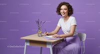 Smiling Woman Writing at Desk with Lavender Touch