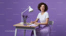 Smiling Woman Writing at Desk with Lavender Decoration