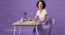 Smiling Woman in Purple Skirt Writing at Desk with Lavender