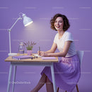Smiling Woman Writing at Elegant Purple Desk