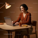Woman Smiling While Working on Laptop at Cozy Home Office
