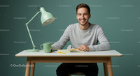 Smiling Man Working at a Modern Desk with Notebook and Lamp