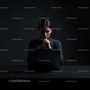 Businesswoman Deep in Thought Behind Laptop
