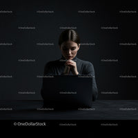 Businesswoman Deep in Thought Behind Laptop