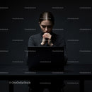 Pensive Woman Deep in Thought with Laptop in Dim Lighting