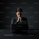 Focused Woman Working on Laptop in Dark Room