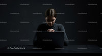 Focused Woman Working on Laptop in Dark Ambiance