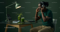 Man with Headphones in Modern Green Workspace