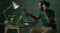 Man Engaged in Digital Work at a Modern Green Workspace