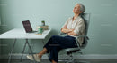 Mature Woman Relaxing in Minimalistic Office Environment