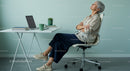 Senior Woman Taking a Relaxing Break in Modern Office