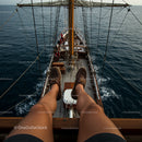 Relaxing on a Wooden Sailboat Deck in Open Seas
