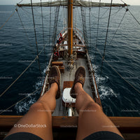 Relaxing on a Wooden Sailboat Deck in Open Seas