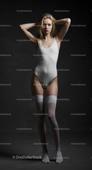 Graceful Woman in White One-Piece Outfit in Studio Setting