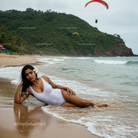 Woman Relaxing on Tropical Beach in White Swimsuit