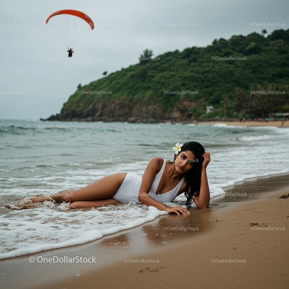 Woman Relaxing on a Tropical Beach with Parasailer in Background