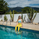 Woman Relaxing Poolside with Cacti and Mountain View